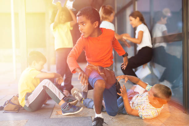 istock Group of children playing near school 1365421453