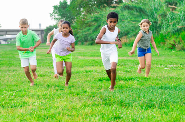 istock Children running on green grass 1365421890