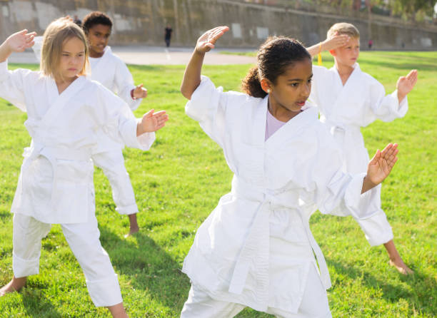 istock Children in kimono practicing karate in summer outdoors 1365422512