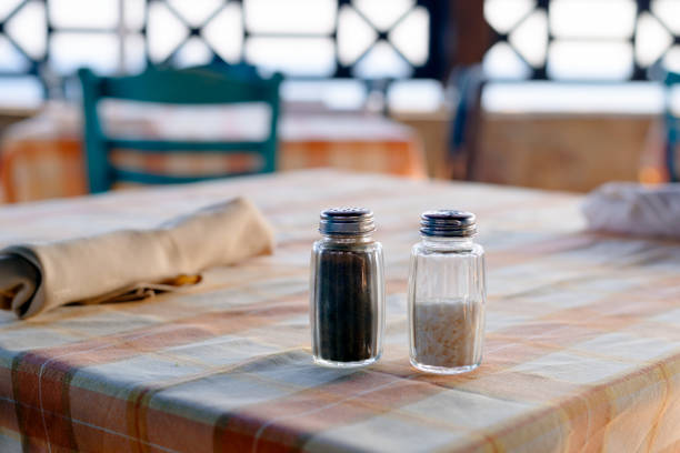 Salt and black pepper on the table in Greek taverna selective focus