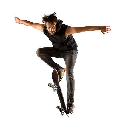 Skateboarder doing a jumping trick. Freestyle extreme sports concept isolated on white background