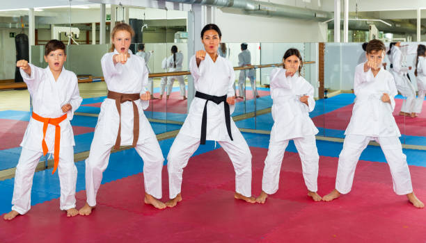 istock Karate kids doing kata in gym 1365423781