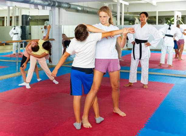 istock Kids in pair exercising self-defense movements 1365423785