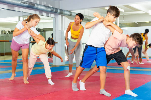 istock Two boys learn to do a painful hand grip in self-defense lesson 1365423794