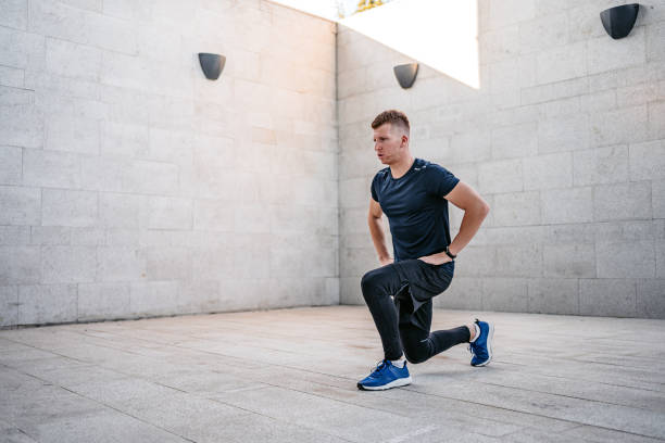 istock Young Man Doing Lunges Outdoors 1365423961