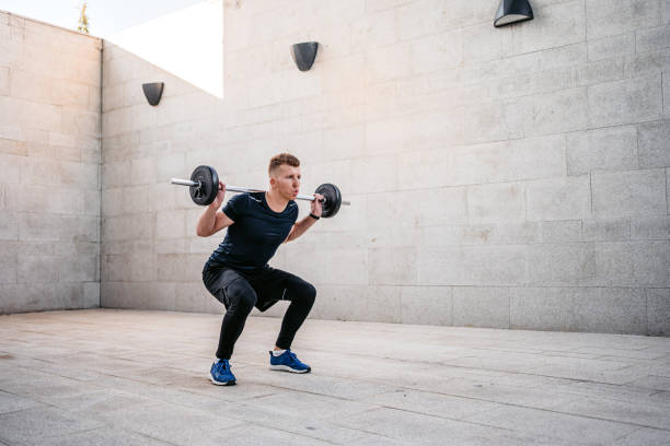 istock Young Man Doing A Barbell Back Squat Outdoors 1365423997