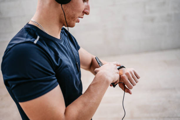 istock Young Man Checking A Fitness Tracker 1365424067