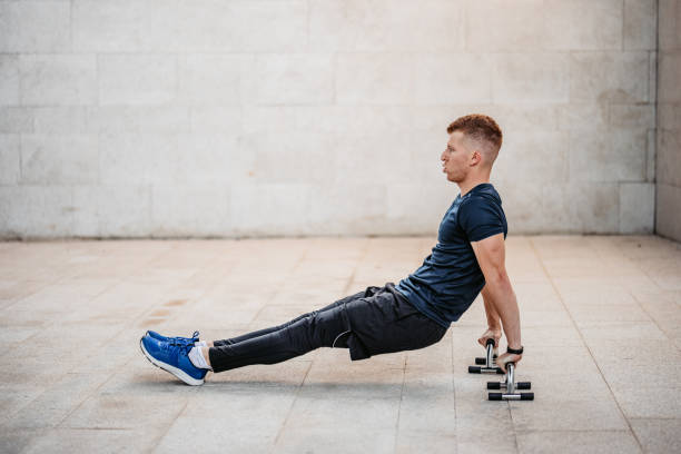 istock Young Man Doing Tricep Dips Outdoors 1365424793