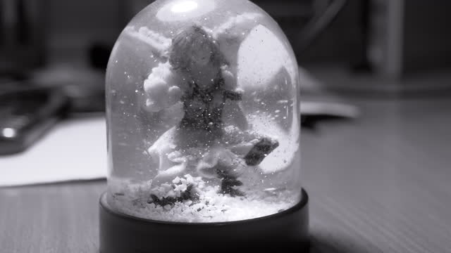 Christmas Snow Globe with an Angel Inside and Falling Snowflakes. Close up