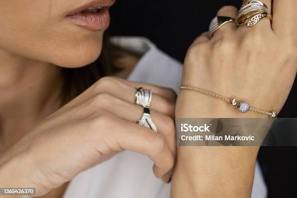 Woman A Lot Of Jewelry On Herself Stock Photo - Download Image Now - Jewelry, Bracelet, Silver Colored