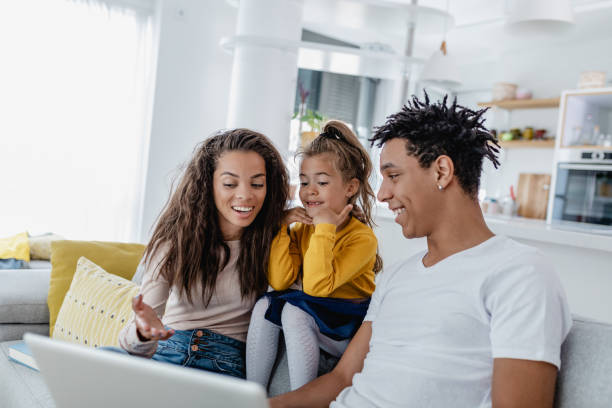 istock Young multi ethnic family is using laptop at home 1365426522