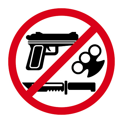 No weapons sign with red round and symbols of knife, gun and brass knuckles.