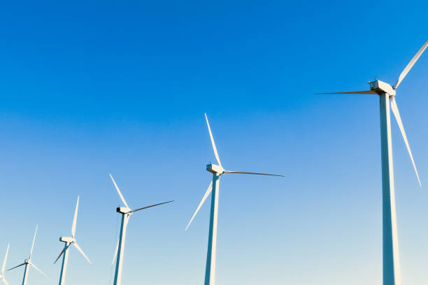 a wind turbines farm hillside row renewable energy clear blue sky