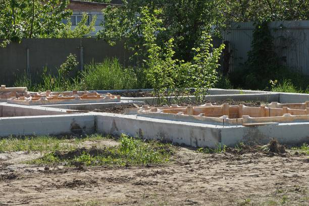 istock gray concrete foundation with brown wooden formwork on a construction site 1365428271