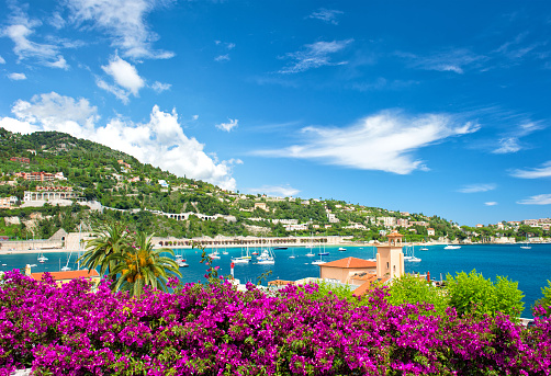 Mediterranean landscape with sea, sky, rhododendron flowers. French reviera, view of Villefranche-sur-Mer near Nice and Monaco