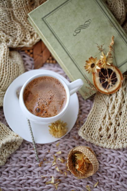 istock Still life with coffee with dried flowers on a knitted fabric 1365431615