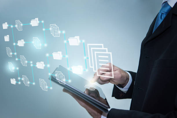 istock Businessman touching icons on digital tablet. Document Management System, online documentation database and process automation to efficiently manage files, future technology 1365431675