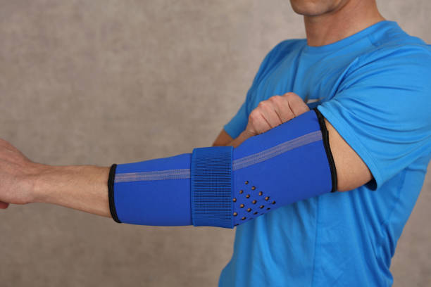 istock Man doing warming up exericeses : Elbow joint injury rehabilitation concept 1365432252