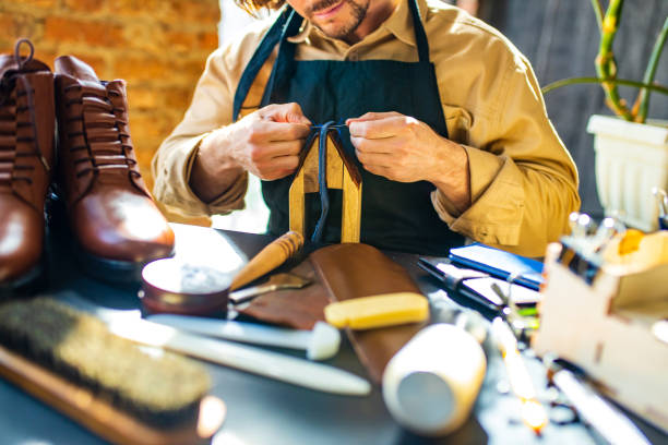 istock skilled shoemaker make a leather shoes in workshop 1365433707
