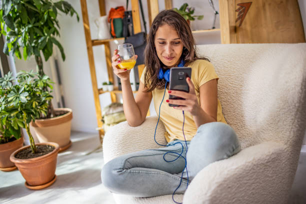 istock Woman using mobile phone at home 1365433943