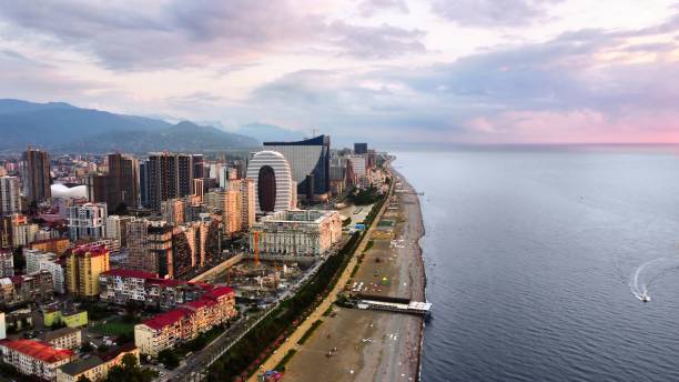 Aerial drone view of Batumi, Georgia at sunset Aerial drone view of the coastline. Black sea, buildings, greenery, mountains, cloudy sky batumi stock pictures, royalty-free photos & images