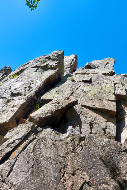 istock crumbling rocks fallen off the cliff with cracks 1365436138
