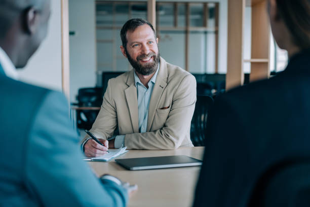 istock Group of business persons talking in the office. 1365436558