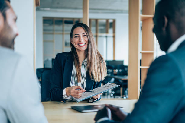 business persons having meeting in an office. - women men signing business imagens e fotografias de stock