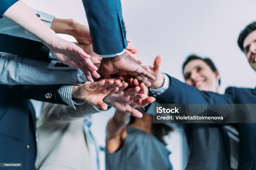 Motivating the team. Shot of multi-ethnic group of business people with stacked hands showing unity and teamwork. Successful business people stacking hands in the office. Loyalty Stock Photo