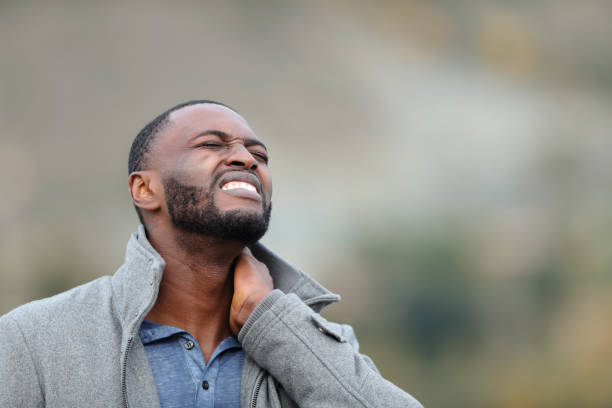 istock Man with black skin suffering neck ache in winter 1365437274