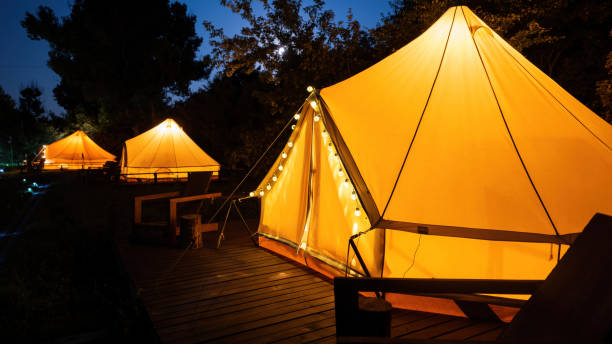 istock Glamping at night, few glowing tents 1365437979