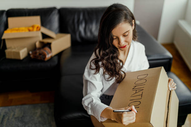 istock Woman packing donation box 1365438265