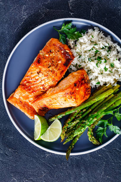 istock fried salmon fish fillet with rice and asparagus 1365439889