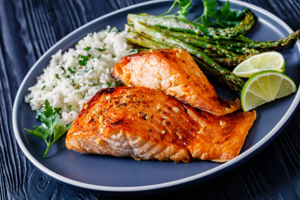istock fried salmon fish fillet with rice and asparagus 1365439890