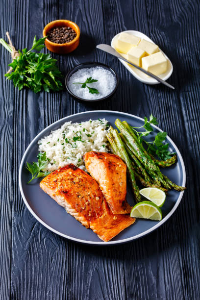 istock fried salmon fish fillet with rice and asparagus 1365439951