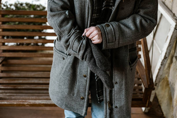 istock Young woman putting winter gloves on 1365440953