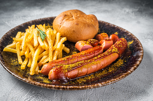 Healthy protein breakfast, hotdog sausages and eggs, old cheese with truffles and fresh organic Spanish onion, served on a metal plate, on wooden home, bar or restaurant table, a close up image with a copy space, top view image