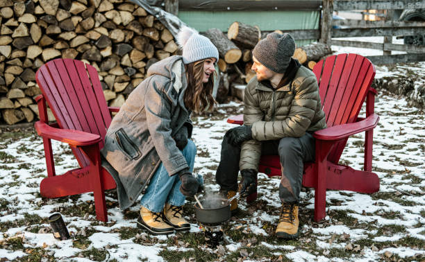 istock Young couple making hot chocolate drink outdoors 1365441105