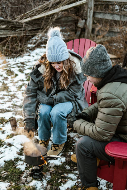 istock Young couple making hot chocolate drink outdoors 1365441120