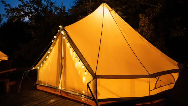Glamping at night, glowing tent, nightlights