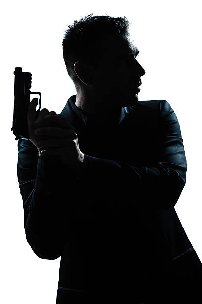 silhouette mann portrait mit waffe - gun men handgun spy stock-fotos und bilder