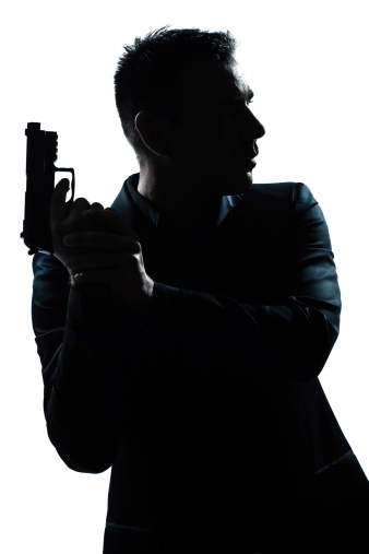 one caucasian spy criminal policeman detective man holding gun portrait silhouette in studio   on white background