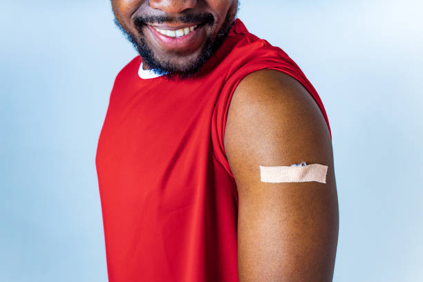 istock vaccinated mixed race showing an adhesive bandage on shoulder after injection studio background 1365442877