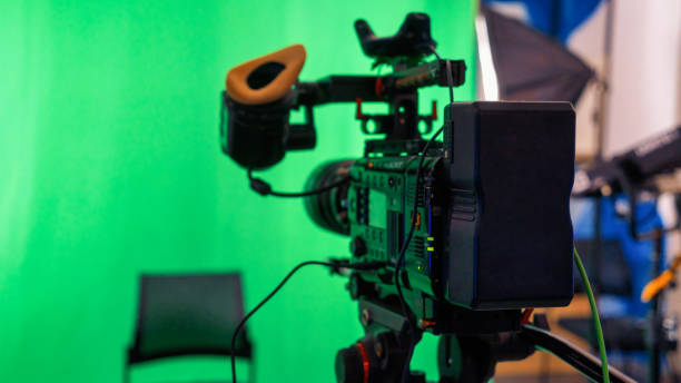 istock Professional video camera on a stand with green chromakey 1365443864