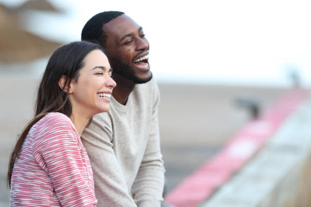 istock Interracial couple laughing dating in a pier 1365444077
