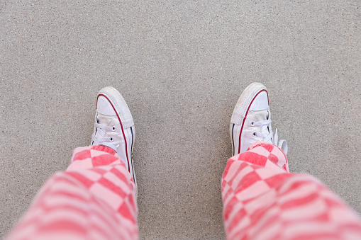 Looking down pink checkered pants