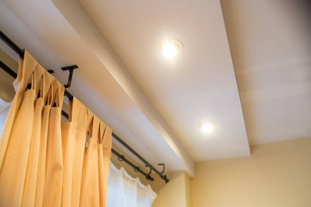 istock Modern curtain in hotel on warm feeling. Yellow curtains, Windows, multi-level ceiling.New real estate property, no people. Inside of elegant corner in room interior.multilevel ceiling 1365444551
