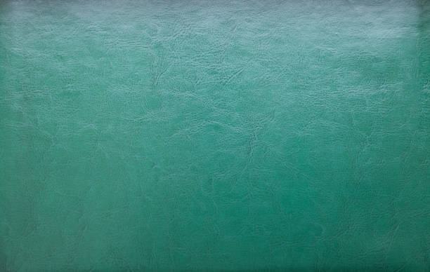 istock a natural green leather texture. close up.texture background with leather lines markings effect, full frame. Close up detail of textured sheet of green color organic art paper. Background rough wall emerald color. 1365444660