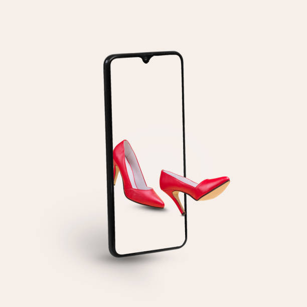 istock Smartphone with elegant red high heels shoes on a gray background. 1365445908