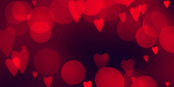 istock Dark red texture background for Valentines day. Copy space with red hearts bokeh lights 1365447272